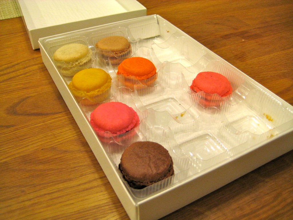 Small, brightly colored macaroons in a box