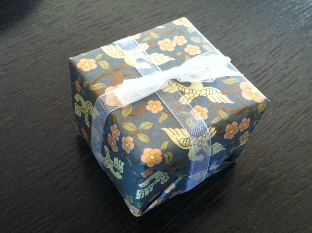 Small box wrapped in floral paper and tied with a bow