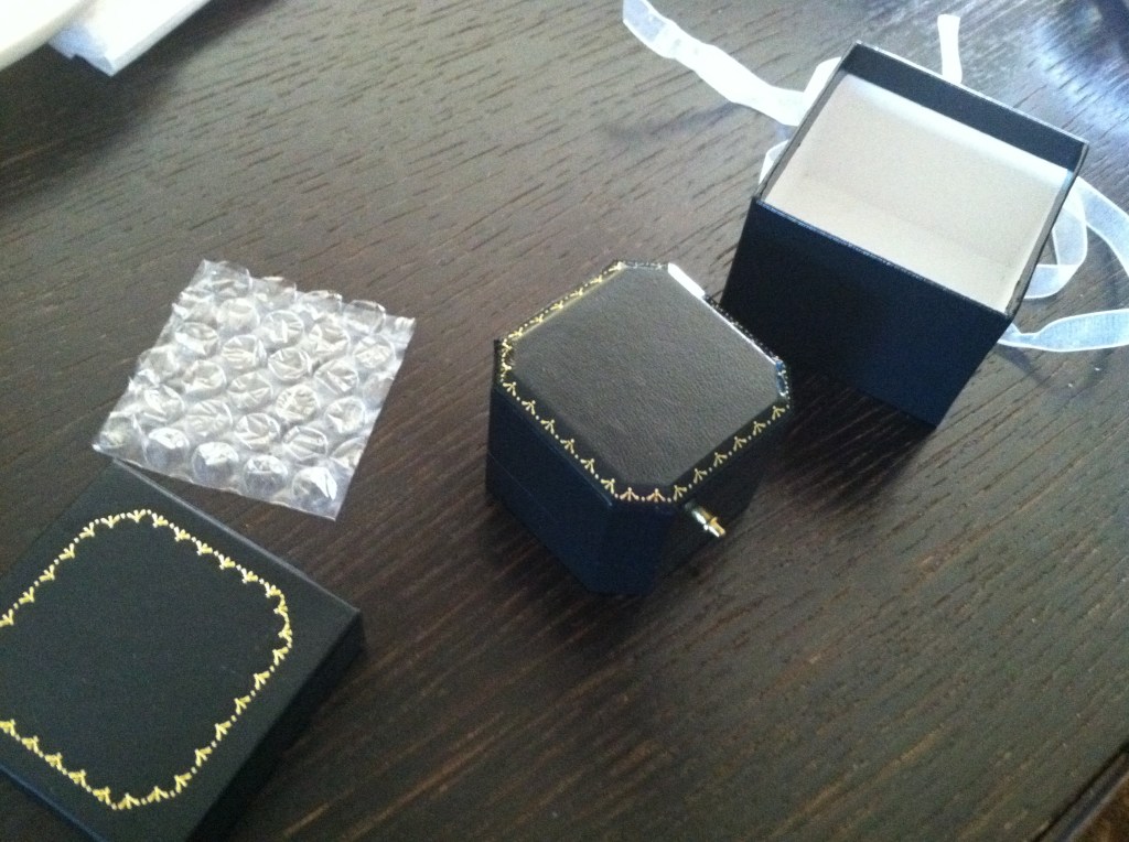 Outer black box opened to reveal the hinged box inside