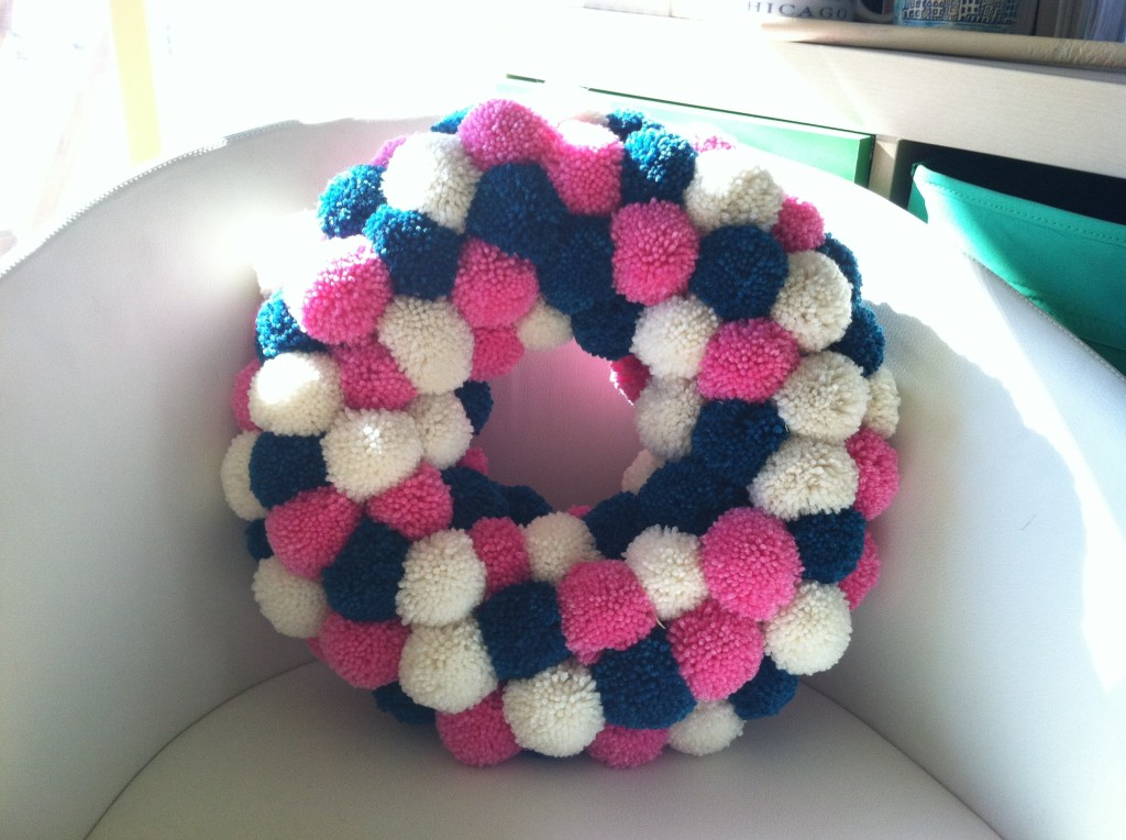 Wreath made of pink, white, and teal pom-poms