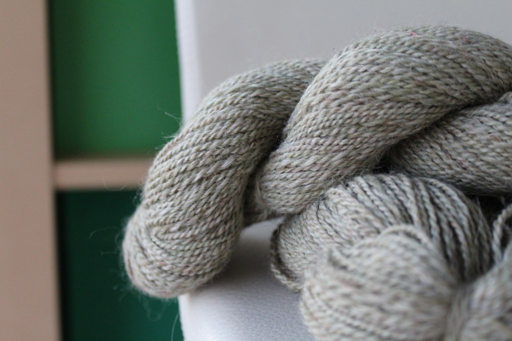 Skein of pale green tweed yarn