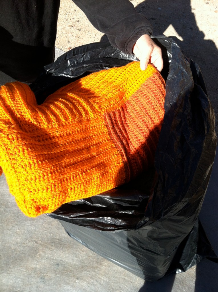 First orange blanket coming out of a bag