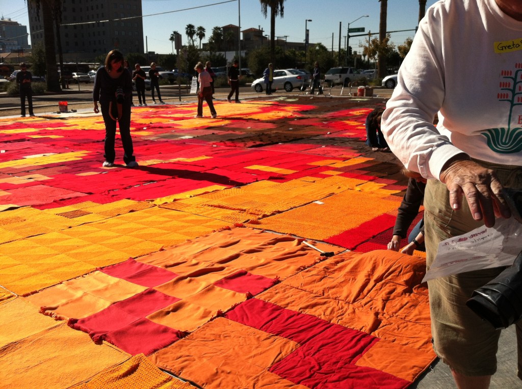 Volunteers adjusting blankets at the Ground Cover installation