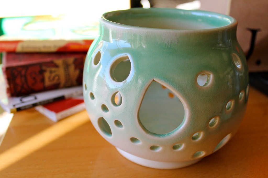 Turquoise yarn bowl with many cutouts