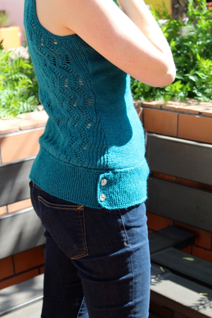 Waist detail of knitted teal tank top