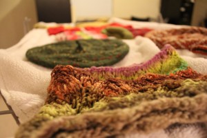 Handknits drying on a white towel