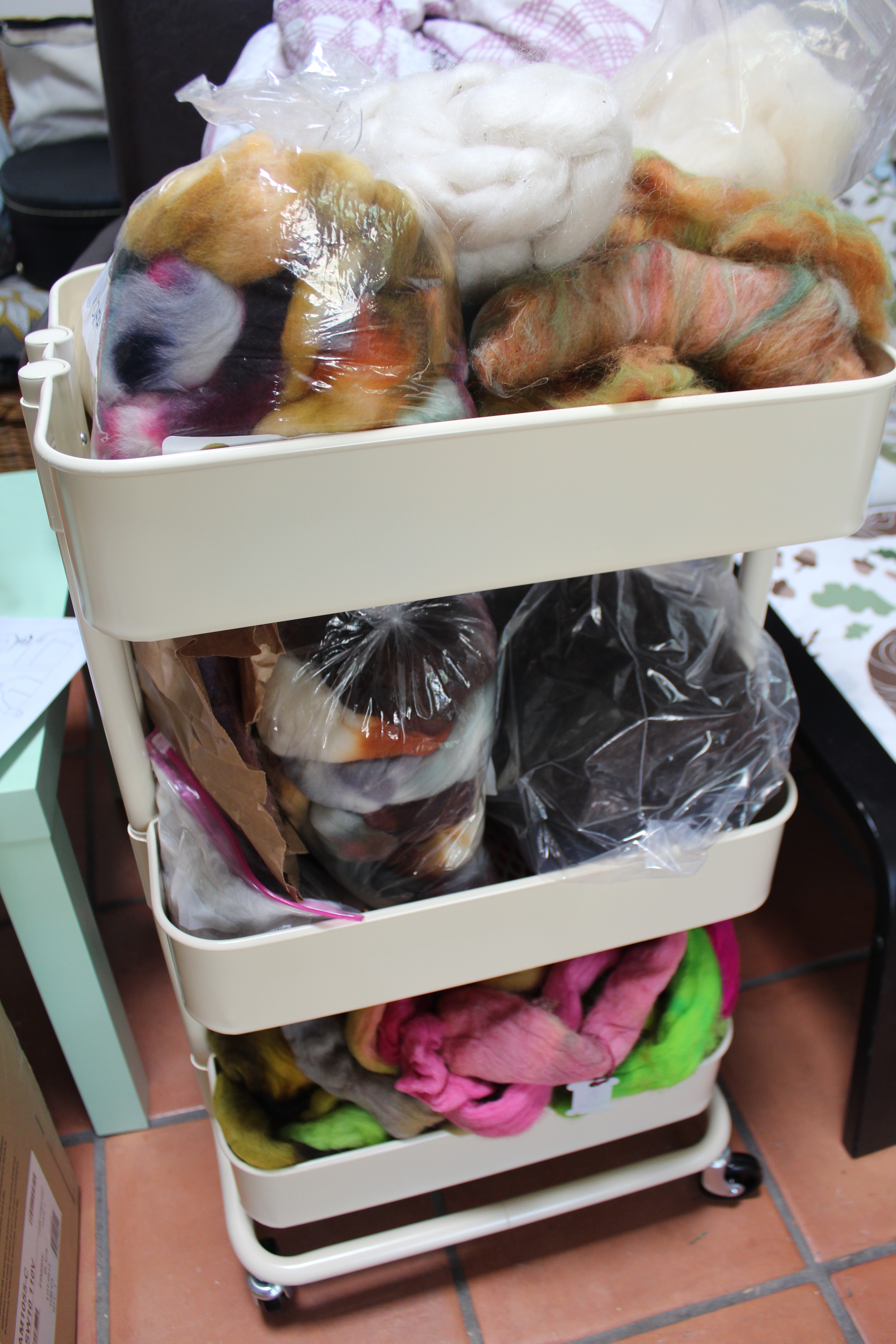 Ikea rolling cart piled high with spinning fiber