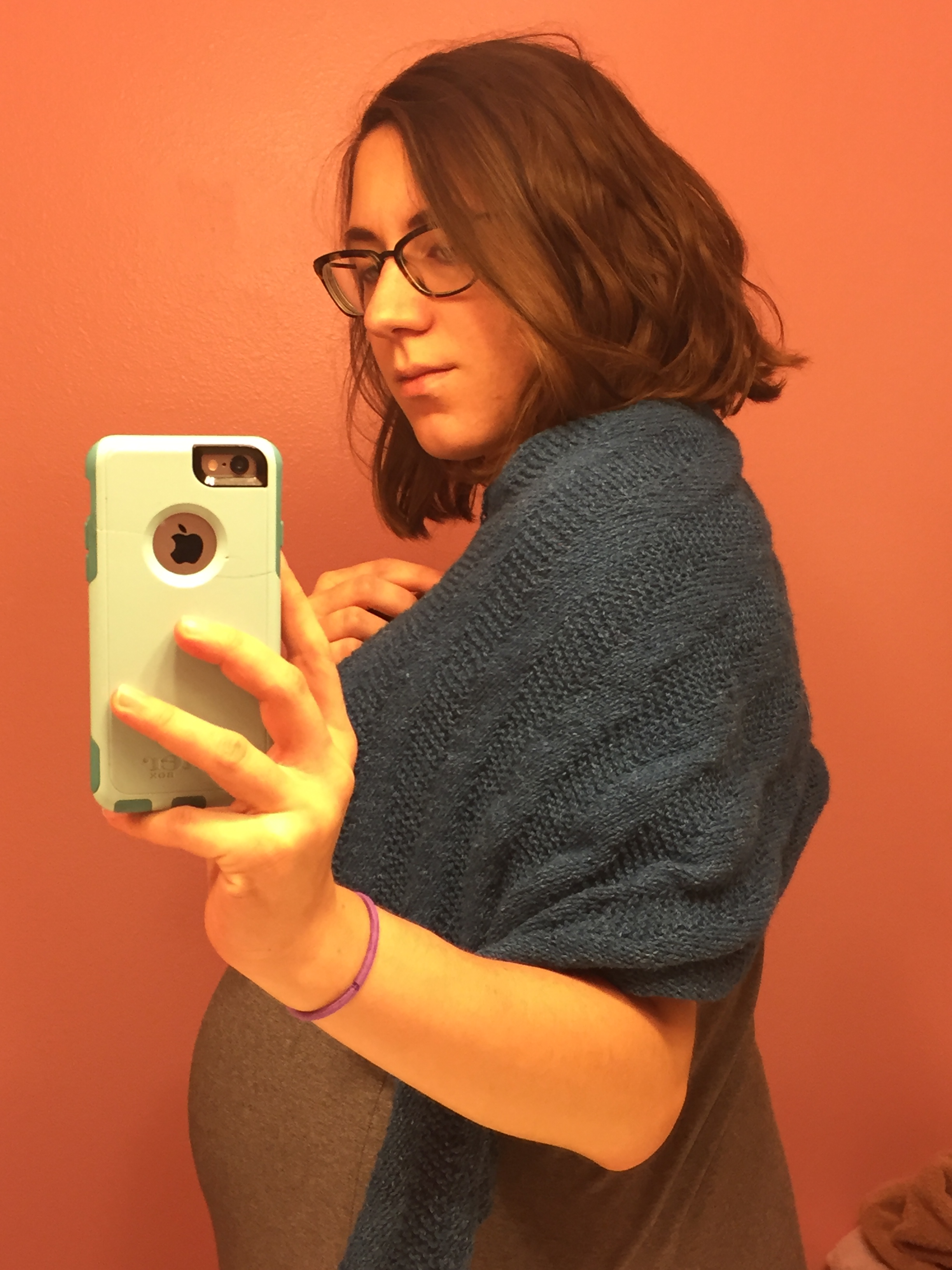 Woman in gray dress modeling a blue Sixth Degree Shawl by Hands Occupied