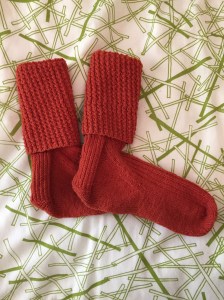 Finished Rick and Roll socks in orange Quince and Co Finch yarn