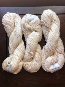 Undyed Cestari Old Dominion Collection DK cotton on a dark wood background
