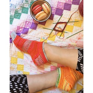 Picture of Jelly Roll socks by Mara Catherine Bryner modeled on feet, image copyright Mara Catherine Bryner