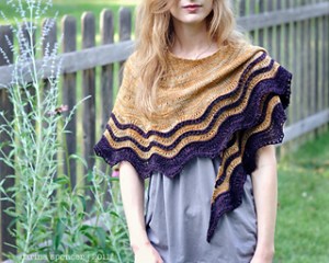 Image of Carina Spencer wearing her Whipporwill shawl in a garden, image copyright Carina Spencer