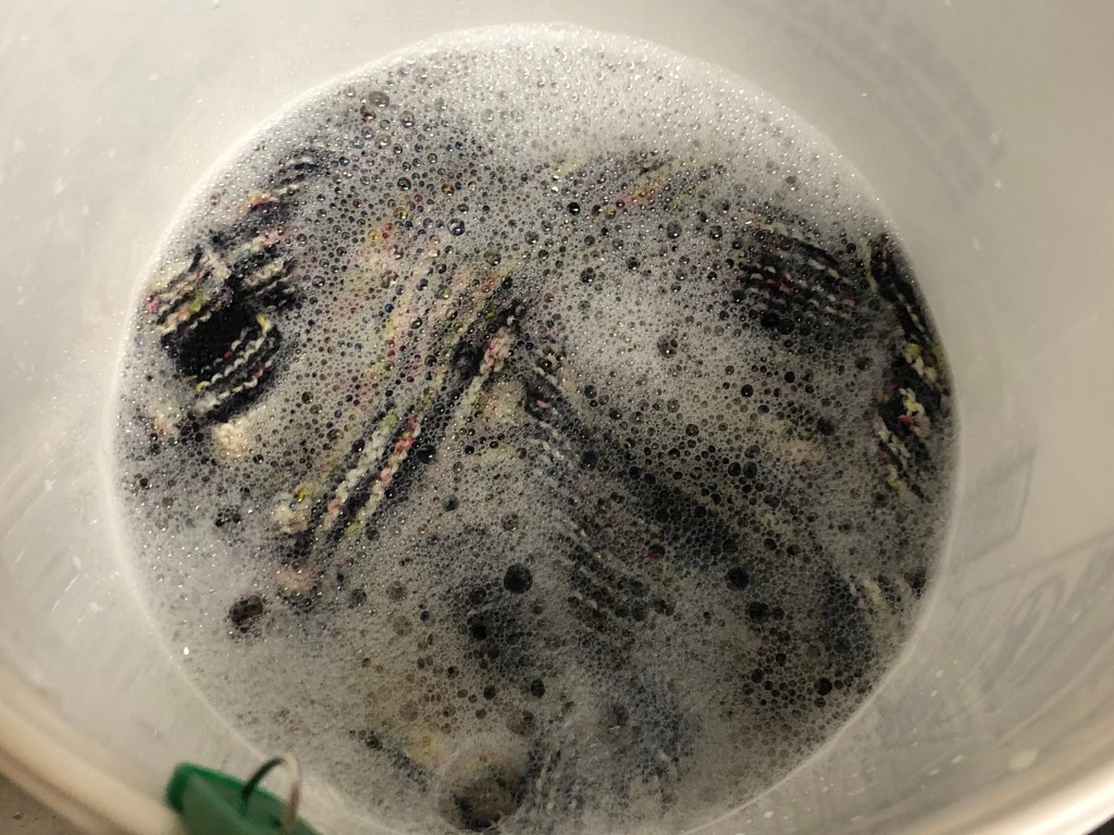 Knitted fabric partially obscured by bubbly water